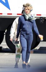 KATE HUDSON Steps Out on Set with Curlers in Her Hair 03/18/2024