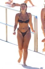 NATASHA OAKLEY in Bikini Out at a Beach 03/25/2024