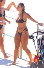 NATASHA OAKLEY in Bikini Out at a Beach 03/25/2024