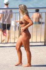 NATASHA OAKLEY in Bikini Out at a Beach 03/25/2024