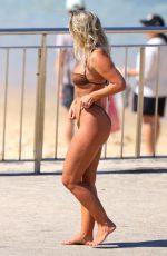NATASHA OAKLEY in Bikini Out at a Beach 03/25/2024
