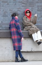 ZOE KRAVITZ Chatting With a Friend on a Loading Dock in New York 03/17/2024