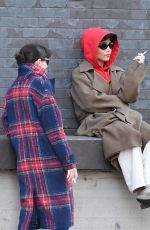 ZOE KRAVITZ Chatting With a Friend on a Loading Dock in New York 03/17/2024