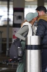 GEORGIA HARRISON Shares a Kiss with Boyfriend at Edinburgh Airport 03/31/2024