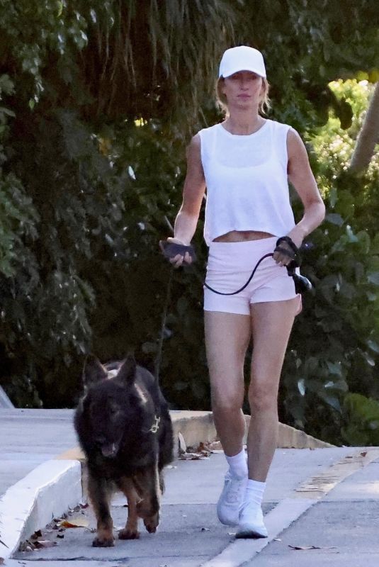 GISELE BUNDCHEN Out for a Morning Walk with Her Dog in Miami Beach 04/24/2024