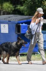 GISELE BUNDCHEN Out with Her Dogs in Miami 04/20/2024