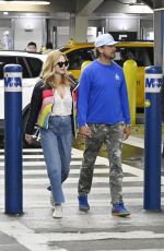 HEATHER GRAHAM and John De Neufville Arrives at Miami International Airport 03/08/2024