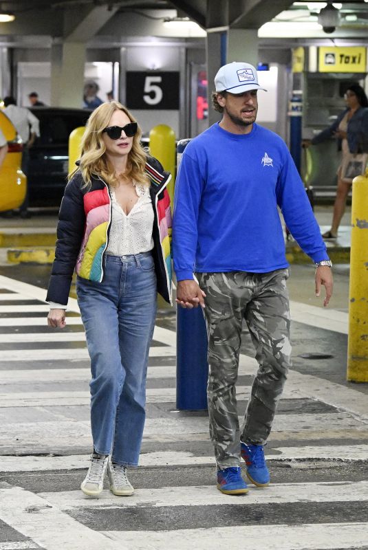 HEATHER GRAHAM and John De Neufville Arrives at Miami International Airport 03/08/2024