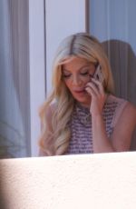TORI SPELLING Takes Phone Call on Hotel Balcony in Los Angeles 03/30/2024