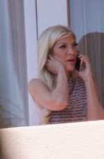 TORI SPELLING Takes Phone Call on Hotel Balcony in Los Angeles 03/30/2024