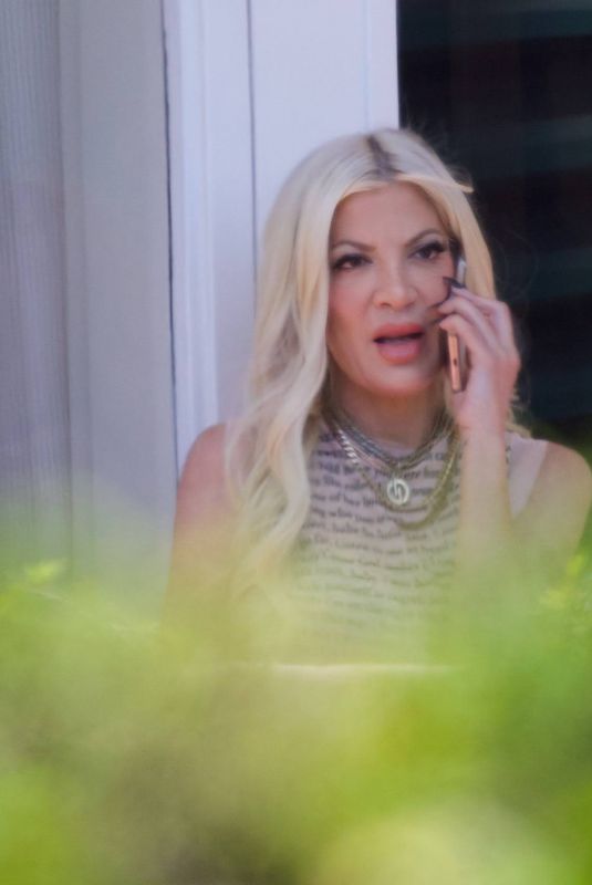 TORI SPELLING Takes Phone Call on Hotel Balcony in Los Angeles 03/30/2024