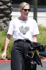 CHARLIZE THERON Leaves Netflix Building with a Friend in Los Angeles 05/08/2024