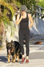 GISELE BUNDCHEN Out for Morning Walk with Her Dog in Miami 05/09/2024