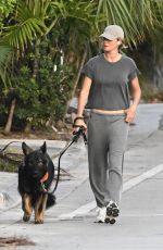 GISELE BUNDCHEN Walks Her Dog Near Her Home in Surfside 05/08/2024