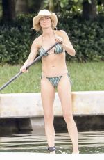 GISELE BUNDCHEN in Bikini Paddle Boarding in Miami 06/15/2024