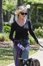 MELANIE GRIFFITH Out with Her Fogs at a Park in Beverly Hills 06/18/2024