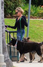 MELANIE GRIFFITH Out with Her Fogs at a Park in Beverly Hills 06/18/2024
