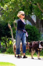 MELANIE GRIFFITH Out with Her Fogs at a Park in Beverly Hills 06/18/2024