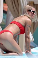 MICHELLE HUNZIKER in a Red Bikini at Alpemare Beach in Forte Dei Marmi 06/03/2024