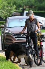 GISELE BUNDCHEN Enjoys an Early Morning Bike Ride in Miami Beach 07/30/2024
