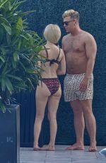 SANDY AOUAD in Bikini and Joey Sint at Rooftop Pool in Los Angeles 07/24/2024