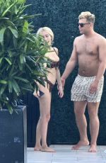 SANDY AOUAD in Bikini and Joey Sint at Rooftop Pool in Los Angeles 07/24/2024