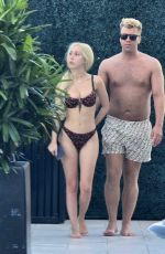 SANDY AOUAD in Bikini and Joey Sint at Rooftop Pool in Los Angeles 07/24/2024