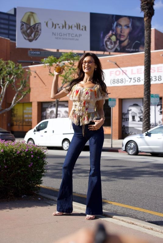 BELLA HADID Posing in Front of Her Orebella Billboard in Los Angeles 08/26/2024