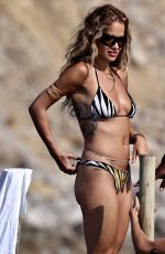 RITA ORA in  Striped Bikini at a Beach in Ibiza 08/22/2024