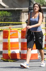 SURI CRUISE in a Cut-off Sweatpants, a Tank Top and Colorful Sneakers Waiting for Subway in New York 08/10/2024