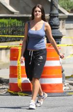 SURI CRUISE in a Cut-off Sweatpants, a Tank Top and Colorful Sneakers Waiting for Subway in New York 08/10/2024