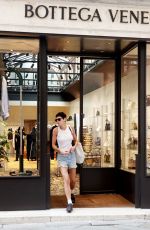 EMMA CORRIN in Denim Shorts Shopping at Bottega Veneta in Venice 08/31/2024