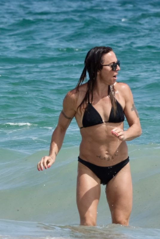 MELANIE CHISHOLM in Bikini at a Beach in Ibiza 09/01/2024