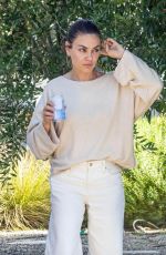 MILA KUNIS Leaves a Friend