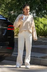 MILA KUNIS Leaves a Friend