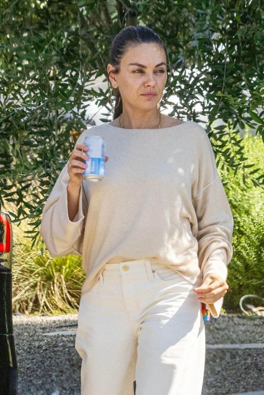 MILA KUNIS Leaves a Friend