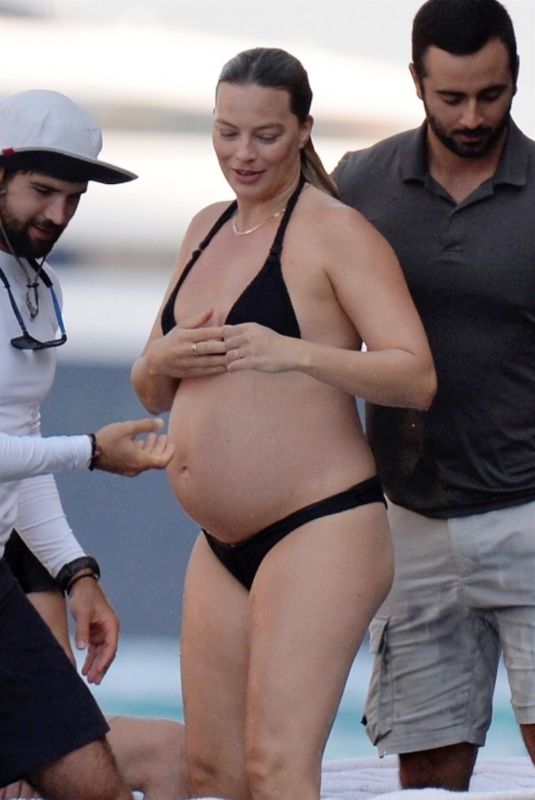 Pregnant MARGOT ROBBIE in a Black Bikini on Vacation in Italy 08/30/2024