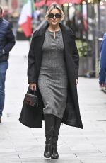 AMANDA HOLDEN and ASHLEY ROBERTS Ride a Tandem Bike at Leicester Square in London 10/03/2024