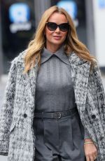 AMANDA HOLDEN and ASHLEY ROBERTS Ride a Tandem Bike at Leicester Square in London 10/03/2024
