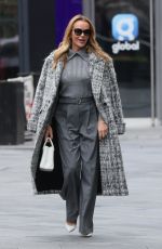 AMANDA HOLDEN and ASHLEY ROBERTS Ride a Tandem Bike at Leicester Square in London 10/03/2024