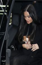 DEMI MOORE Arrives at The Substance Screening with Her Dog Pilaf 12/04/2024