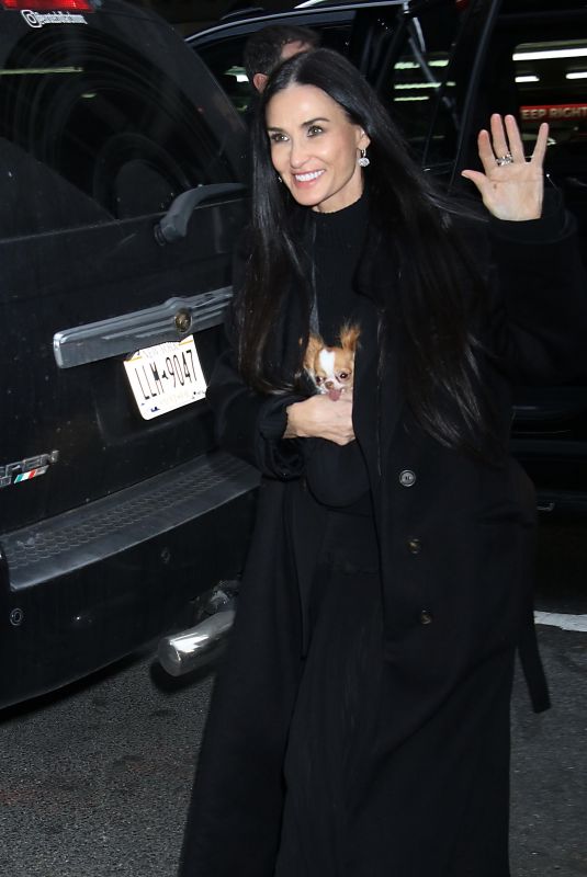 DEMI MOORE Arrives at The Substance Screening with Her Dog Pilaf 12/04/2024