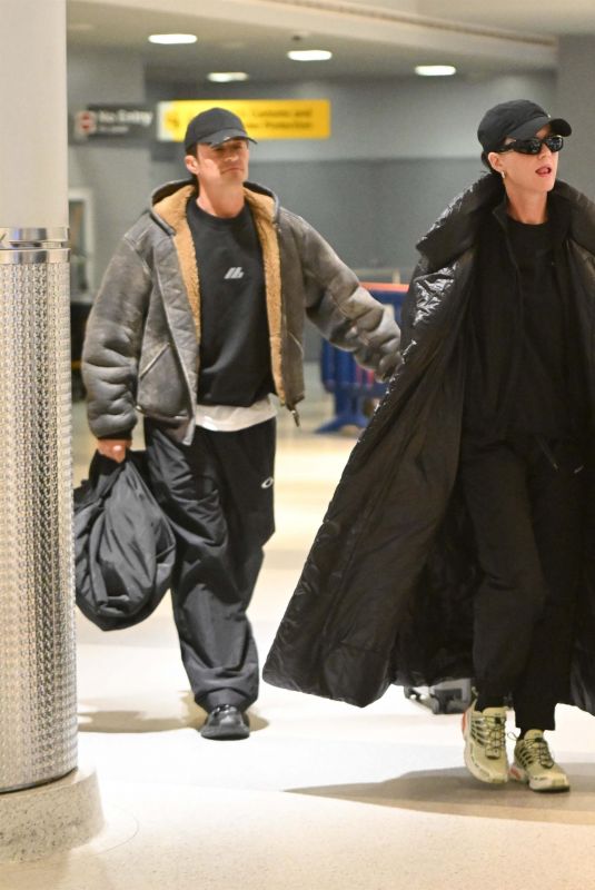 KATY PERRY and Orlando Bloom Arrives at JFK Airport in New York City 12/12/2024