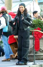 LIZA KOSHY on the Set of The Man with the Bag with Arnold Schwarzenegger, Alan Ritchson and KYLE MOONEY in Bryant Park in New York 12/19/2024