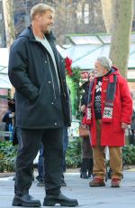 LIZA KOSHY on the Set of The Man with the Bag with Arnold Schwarzenegger, Alan Ritchson and KYLE MOONEY in Bryant Park in New York 12/19/2024