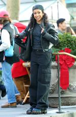LIZA KOSHY on the Set of The Man with the Bag with Arnold Schwarzenegger, Alan Ritchson and KYLE MOONEY in Bryant Park in New York 12/19/2024