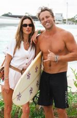 ALESSANDRA AMBROSIO Enjoys a Massage and Cheers on Her Boyfriend Buck Palmer at a Wave Pool Park in Brazil 01/07/2025