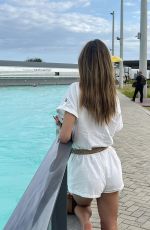 ALESSANDRA AMBROSIO Enjoys a Massage and Cheers on Her Boyfriend Buck Palmer at a Wave Pool Park in Brazil 01/07/2025