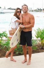 ALESSANDRA AMBROSIO Enjoys a Massage and Cheers on Her Boyfriend Buck Palmer at a Wave Pool Park in Brazil 01/07/2025