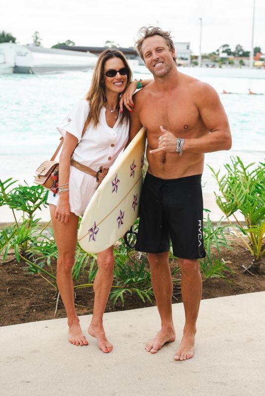 ALESSANDRA AMBROSIO Enjoys a Massage and Cheers on Her Boyfriend Buck Palmer at a Wave Pool Park in Brazil 01/07/2025